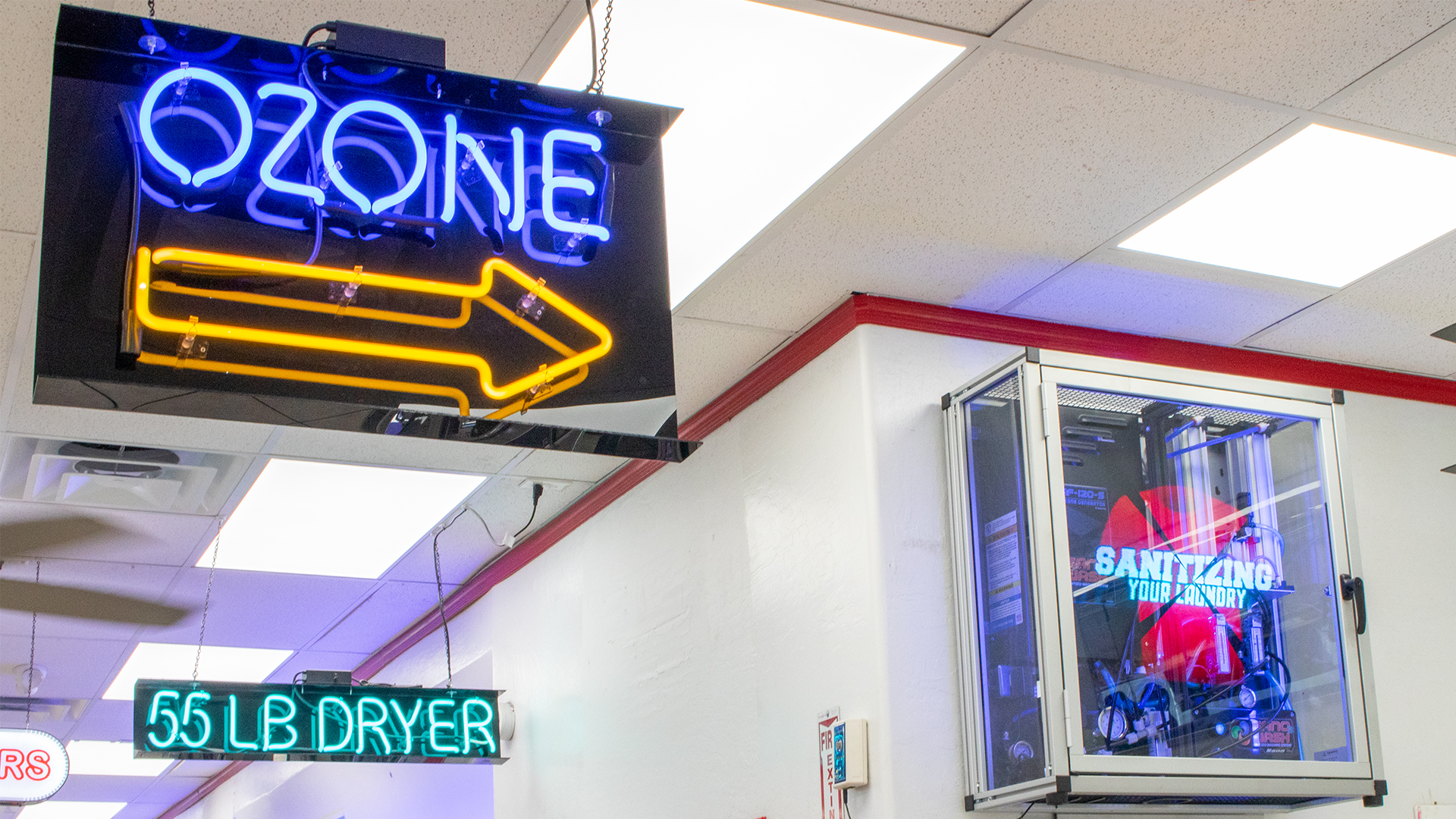 neon sign that reads ozone with arrow pointing to ozone machine